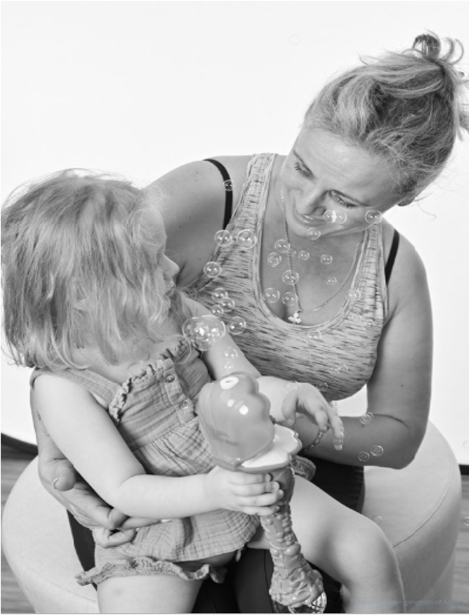 Olivija with her mama, playing with bubbles
